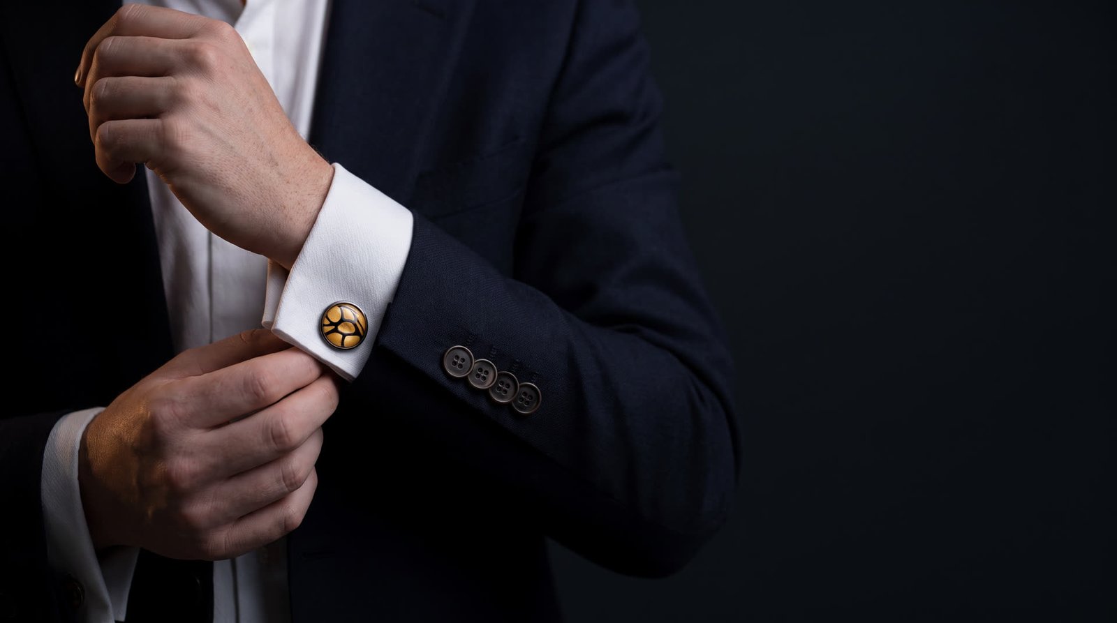 Man in a midnight suit wearing a Wild Shore glass cufflink