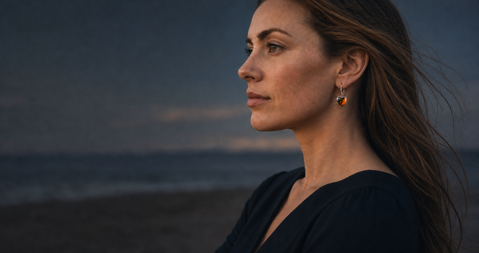 Model wearing Wild Shore heart-shaped fluid art earrings