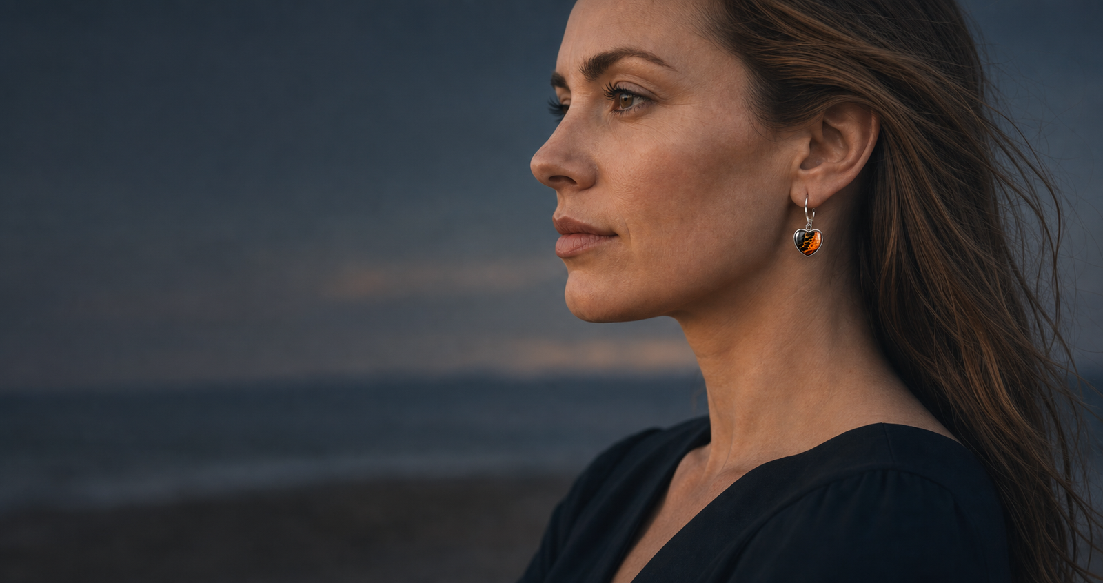 Model wearing Wild Shore heart-shaped fluid art earrings