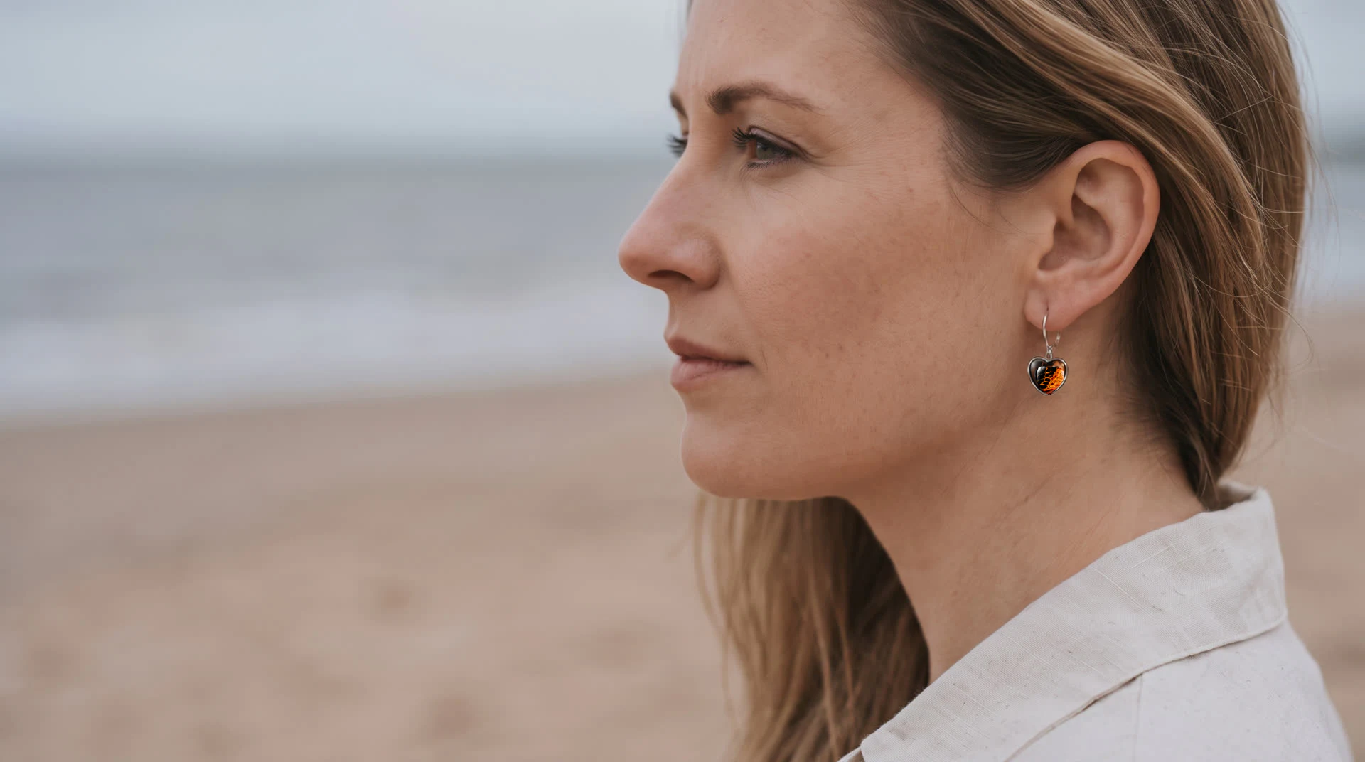 Model wearing Wild Shore heart-shaped fluid art earrings