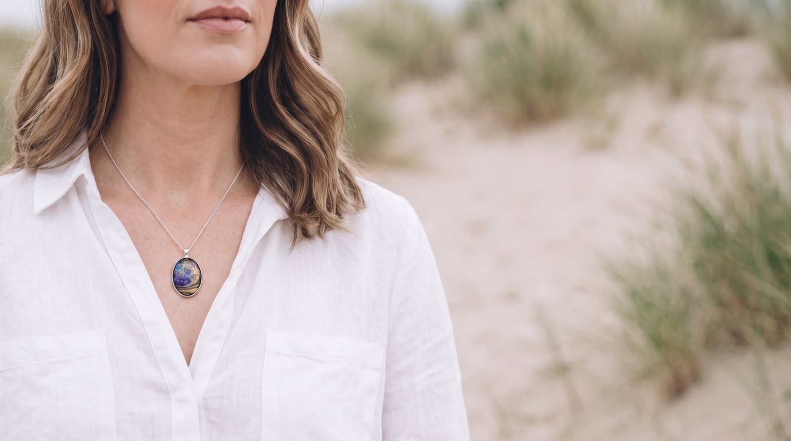 Model wearing a Wild Shore oval fluid art pendant