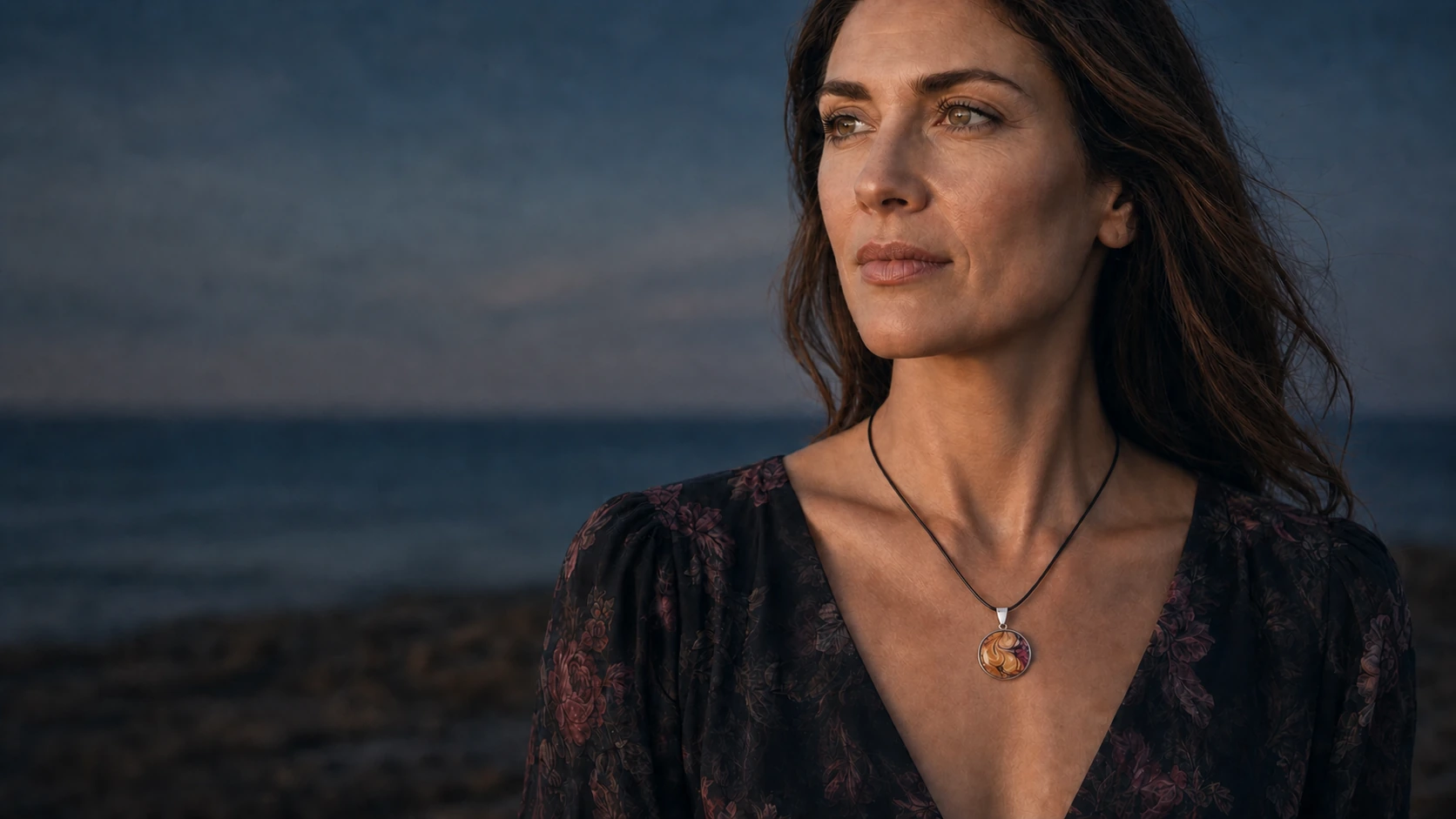 Model wearing a round Wild Shore fluid art pendant on a black cord