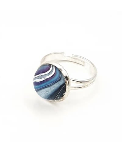 The actual ring — blue fluid art dome on a silver band