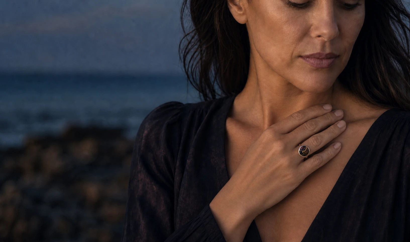 Model wearing a Wild Shore adjustable glass ring with a dark ochre fluid-art design